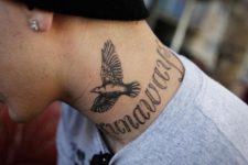 Flying dove tattoo on the neck
