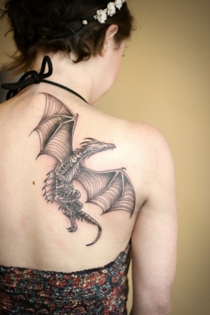 Flying dragon tattoo on the back