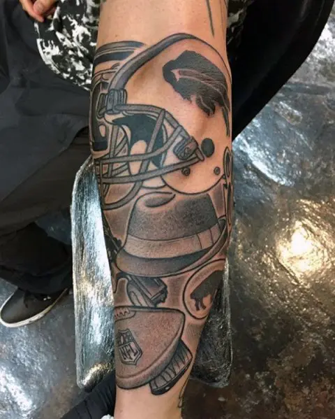 Football and helmet tattoo on the forearm