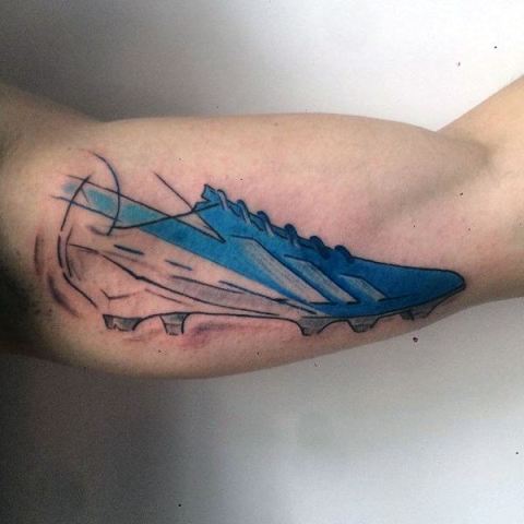 Football boot tattoo on the biceps