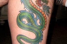 Green dragon tattoo on the leg