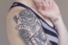 Half-sleeve camera and big flowers tattoo