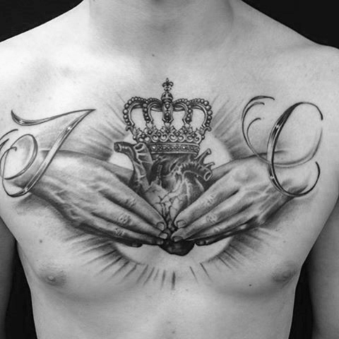 Hands, heart and crown tattoo on the chest