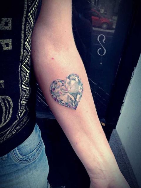 Heart shaped diamond tattoo on the forearm