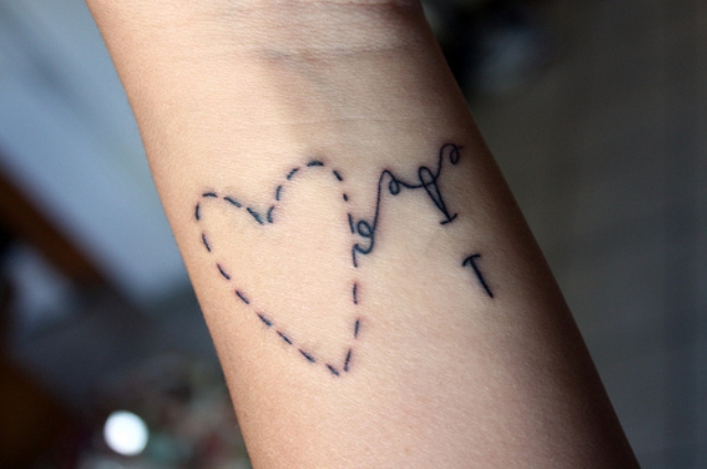 Heart shaped stitches tattoo