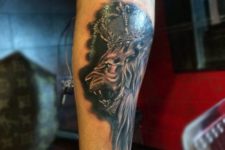 Lion and crown tattoo on the forearm