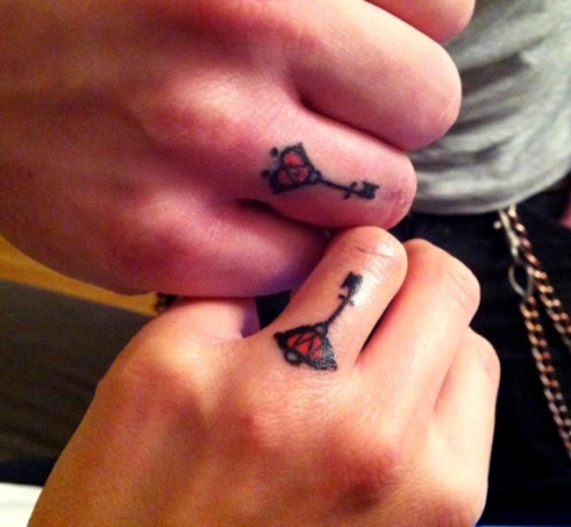 Matching tiny tattoos on the fingers