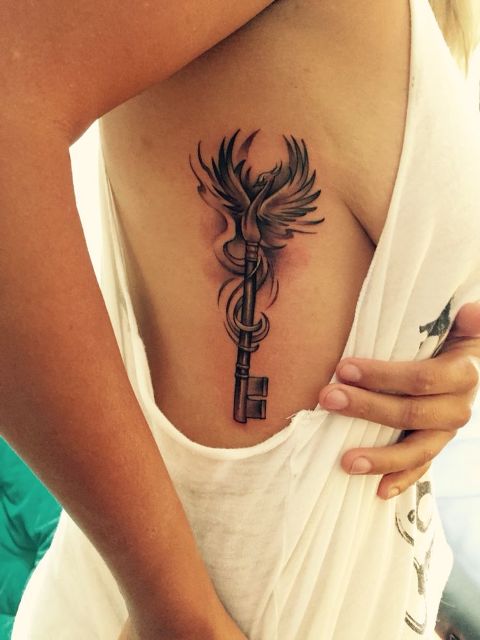 Phoenix and key tattoo on the side