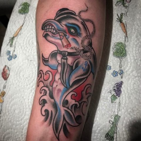 Pirate dolphin tattoo on the arm