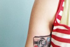 Polaroid camera tattoo on the arm