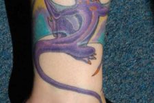 Purple, blue and orange tattoo on the leg