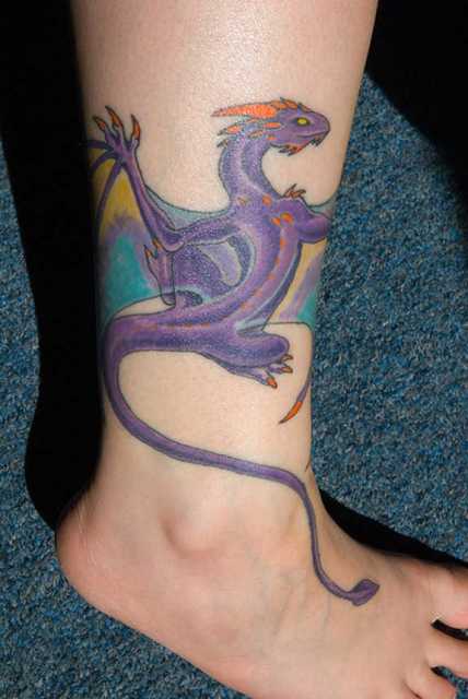 Purple, blue and orange tattoo on the leg