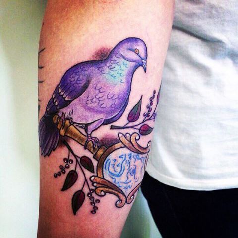 Purple dove tattoo on the hand