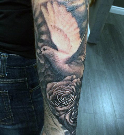 Rose and dove tattoo on the forearm