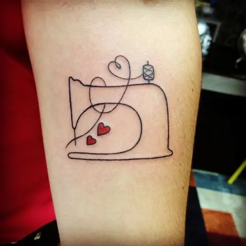 Sewing machine and red hearts tattoo