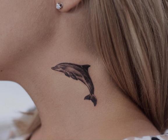 Small dolphin tattoo idea on the neck