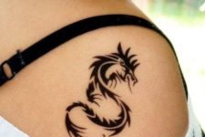 Small tribal dragon tattoo on the shoulder