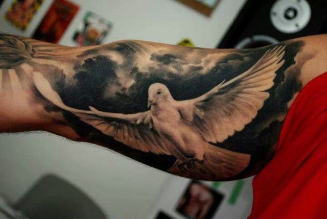 Soaring dove tattoo on the hand
