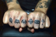 Tiny tattoos on the fingers