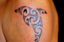 Tribal dolphin tattoo on the shoulder