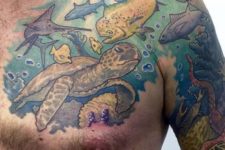 Turtle and fishes tattoo on the chest and arm