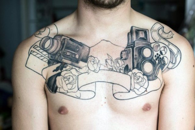 Two cameras and flowers tattoo on the chest