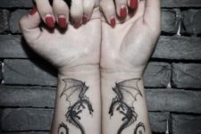 Two dragon tattoos on the both hands