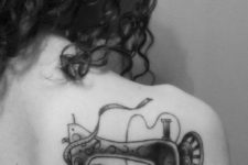 Vintage sewing machine tattoo on the shoulder
