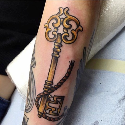 Yellow key and rope tattoo