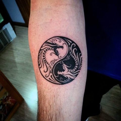 Yin Yang styled dragon tattoo on the hand