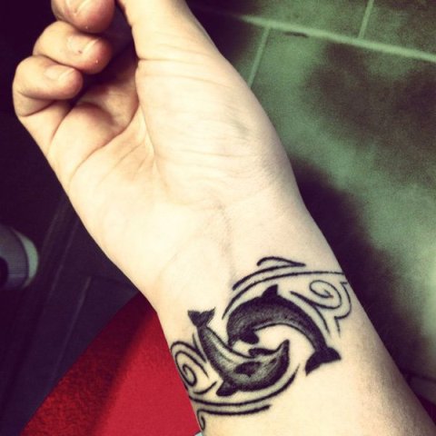 Yin and Yang styled tattoo on the wrist