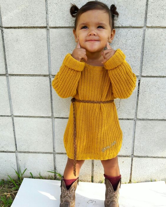 a mustard knit dress with long sleeves, cowboy boots and burgundy socks for a boho feel