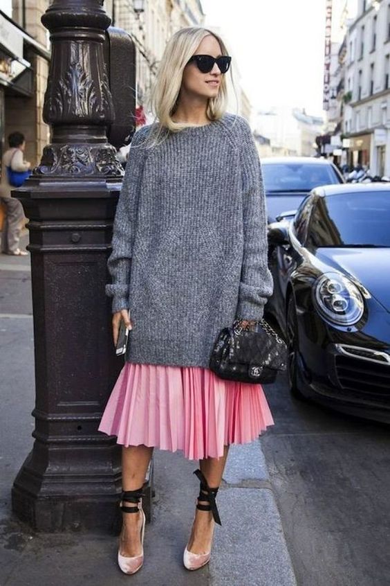 a pink pleated midi skirt, an oversized grey sweater, pink velvet shoes with lacing up