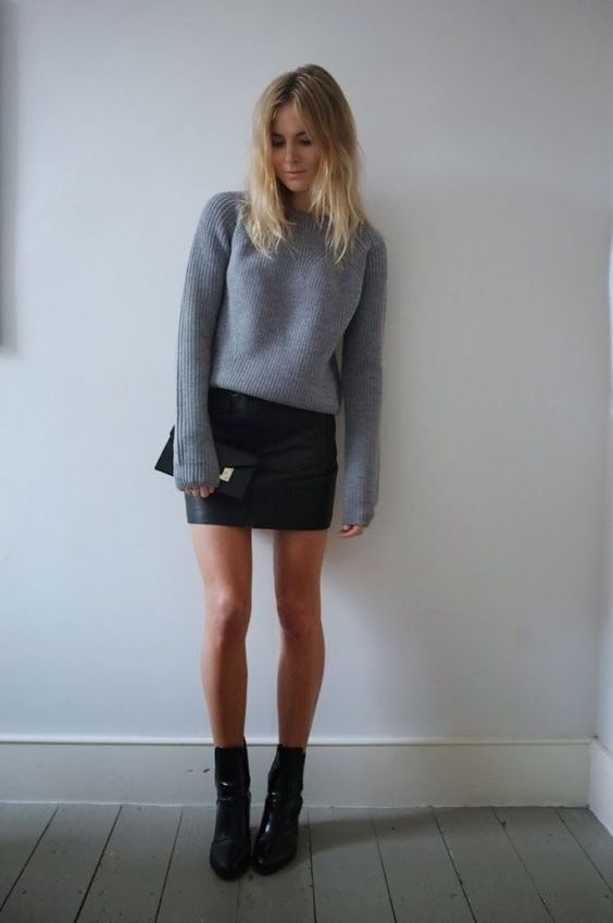 a black leathe rmini skirt, a grey sweater and black leather sock booties