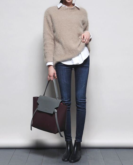 a casual Friday look with a white shirt, a beige sweater, navy skinnies, black booties and a burgundy bag