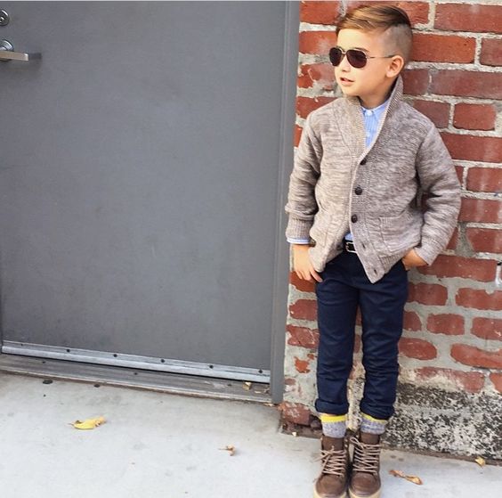 stylish fall boy's look with navy pants, grey sorcks, brown suede boots, a blue shirt and a neutral cardigan