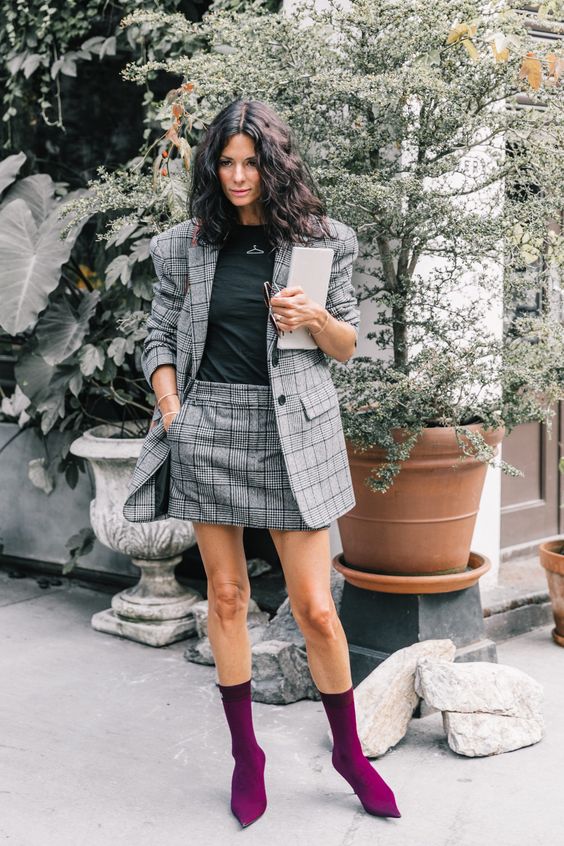 a chic tweed grey suit with a mini skirt, a black tee and bold purple boots