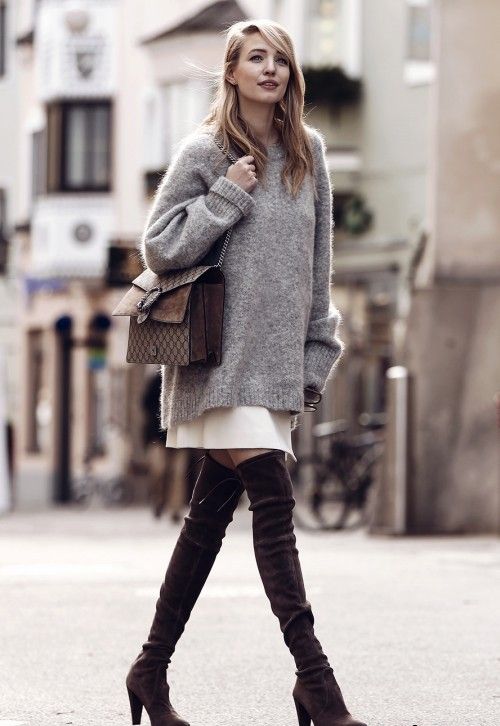 an oversized grey sweater over a white mini skirt, dark brown suede tall boots and a brown bag