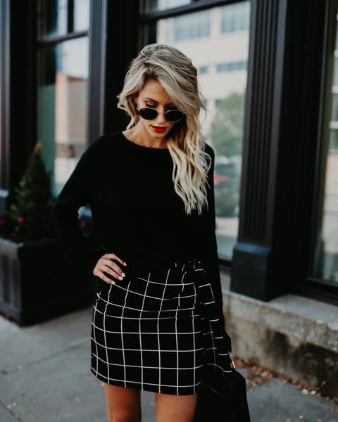 a black top and an off the grid black and white mini skirt, a black bag