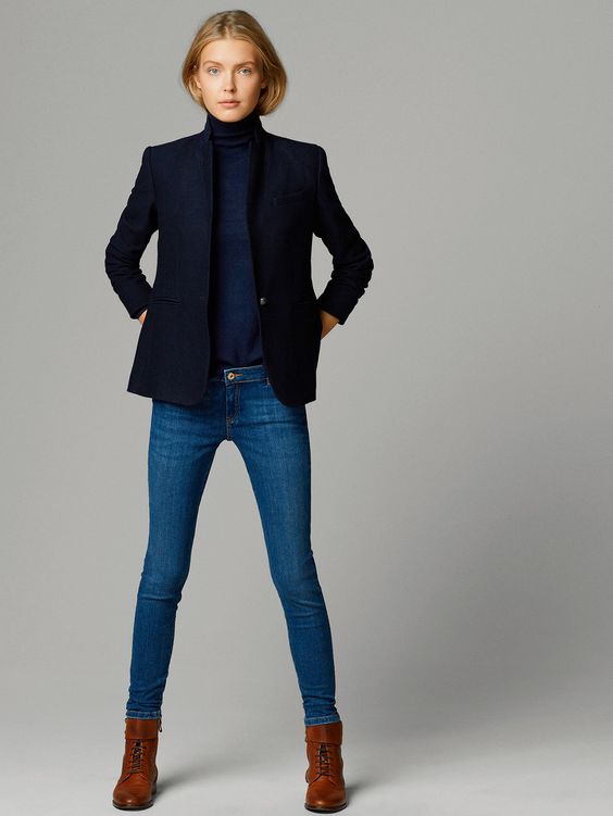 A navy turtleneck, a black blazer, blue jeans and brown boots.