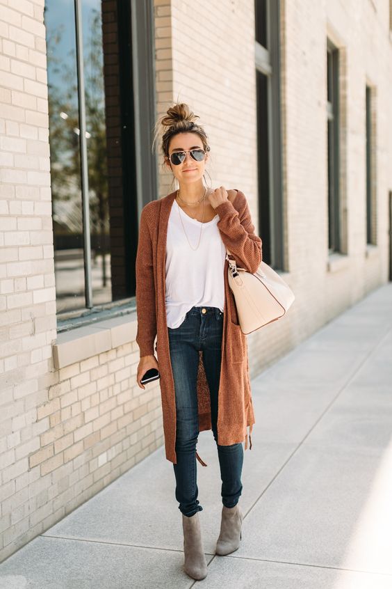 blue skinnies, a white tee, grey suede booties, a burnt orange cardigan for a comfy look