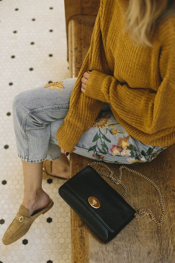 a mustard sweater, floral embroidered denim and mustard moccasins for a boho look