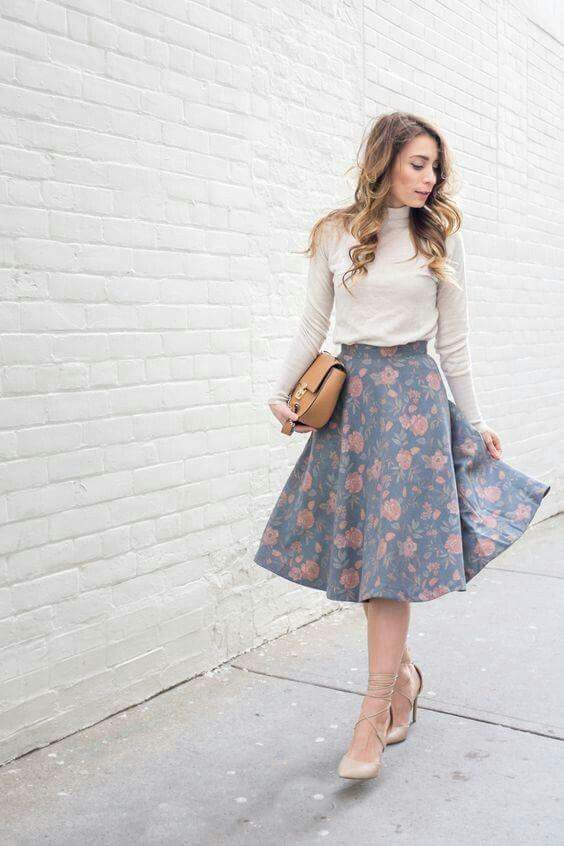 a neutral turtleneck, a pale blue floral print midi skirt, neutral lace up shoes