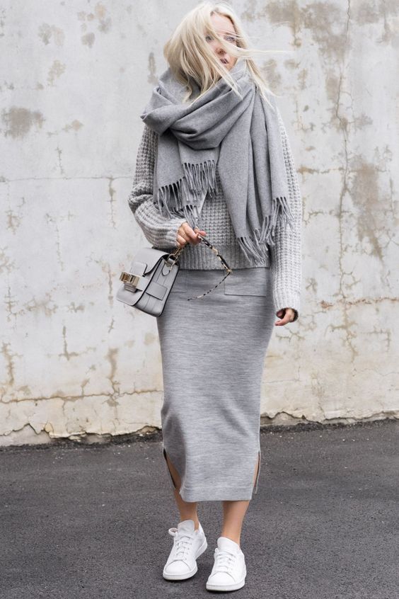 a grey sporty midi skirt, a grey sweater, a grey wrap scarf and white sneakers