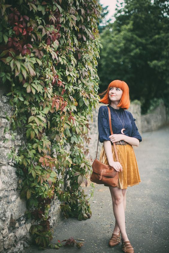 a vintage look with a printed navy shirt, a yellow velvet mini, brown strappy flats and a cognac bag