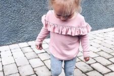 10 a pink shirt with ruffles, grey leggings and grey flats with bows