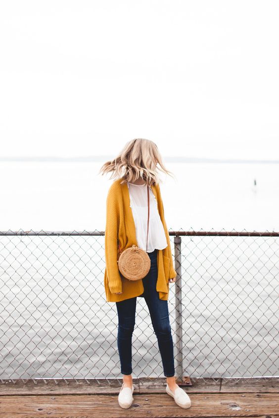 navy jeans, a white top, a mustard cardigan and white moccasins for a weekend look