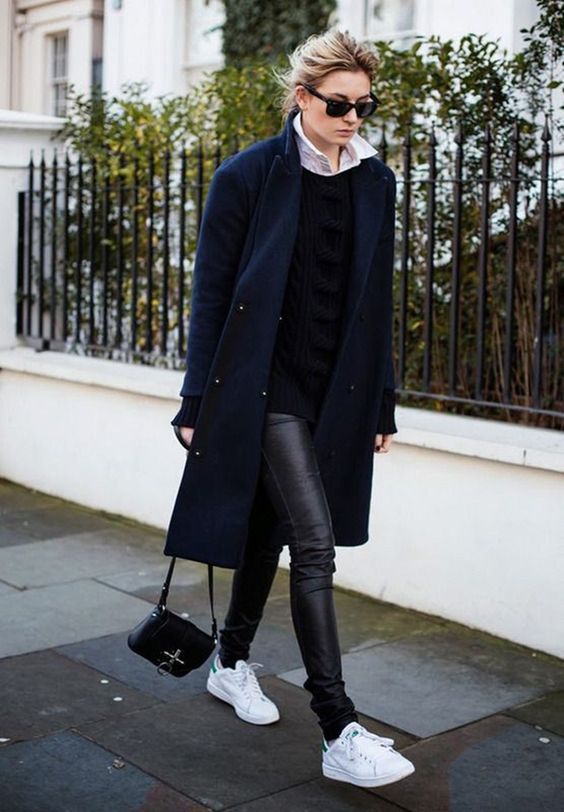 a black leather leggings, white sneakers, a black swetaer and a navy coat