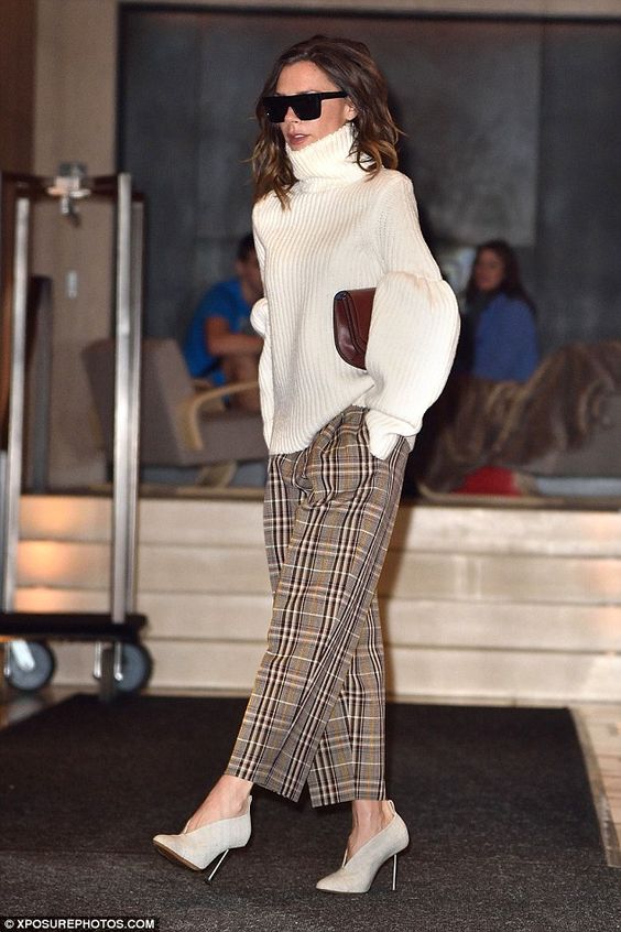 a white oversized sweater with a turtleneck, checked pants and creamy booties