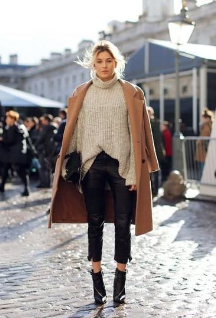 black cropped pants, a neutral turtleneck sweater, black booties and a camel coat